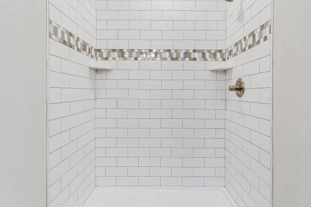 istock Elegant Bathroom Shower With White Tile And Decorative Mosaic Accent. 2163515217