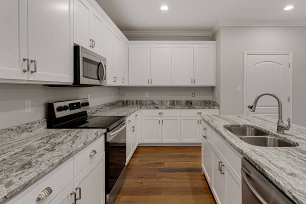 istock Spacious Kitchen With White Cabinets, Granite Countertops, And Wood Floors. 2163515218