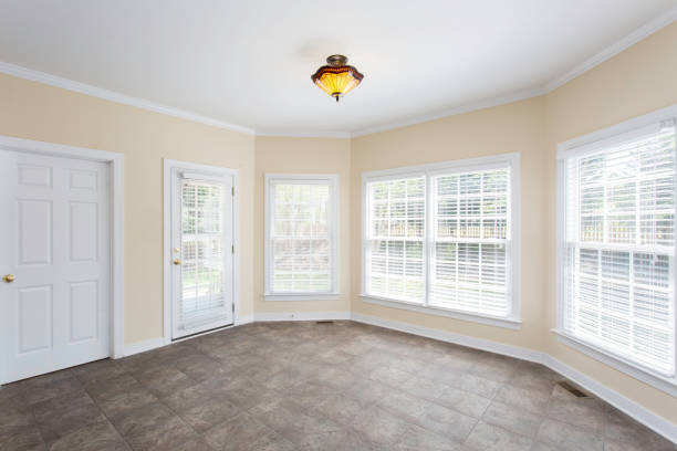 Bright Sunroom With Large Windows And Tiled Floor Inviting Natural Light