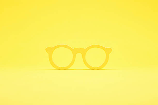Close-up of eyeglasses at a crime scene surrounded by numbered evidence markers under dramatic lighting, indicating forensic investigation.