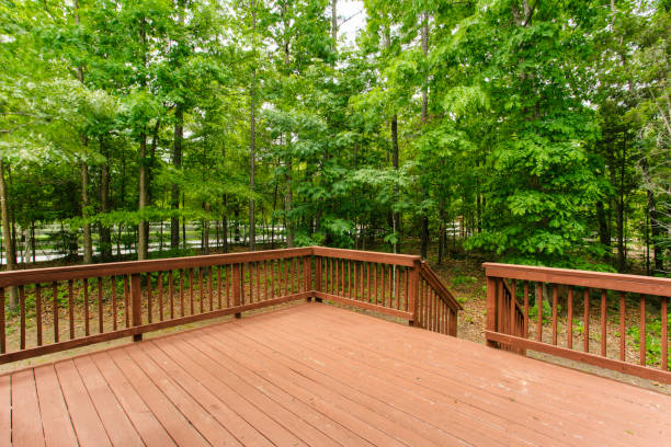 istock Spacious Wooden Deck Overlooking Lush Green Forest In A Serene Setting. 2163515616