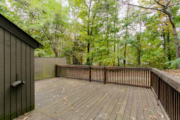 Spacious Wooden Deck In A Secluded Forested Backyard With Serene Ambiance