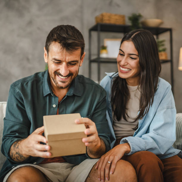 istock Girlfriend surprise her boyfriend for birthday with gift present 2163517504