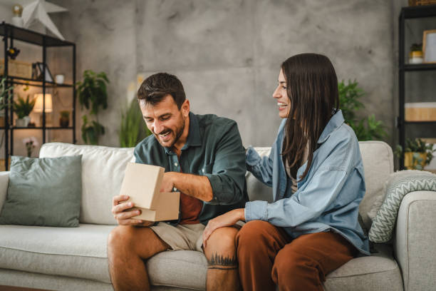 istock Girlfriend surprise her boyfriend for birthday with gift present 2163517592