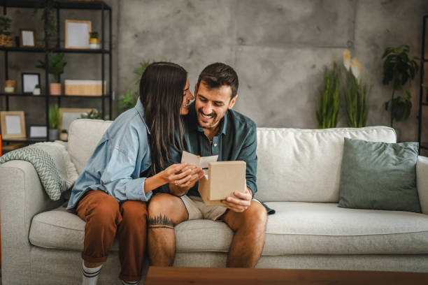 istock Boyfriend read greeting card thank you note from his girlfriend 2163517604