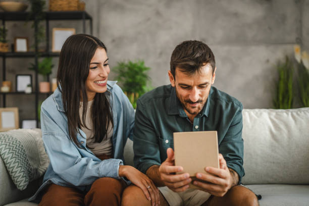 istock Girlfriend surprise her boyfriend for birthday with gift present 2163517669