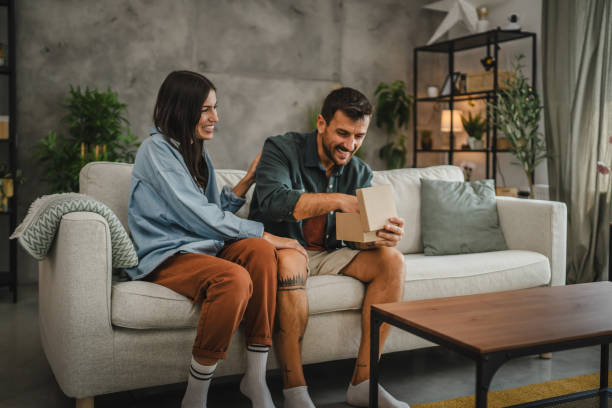istock Girlfriend surprise her boyfriend for birthday with gift present 2163517713