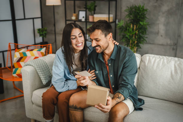istock Boyfriend read greeting card thank you note from his girlfriend 2163517718