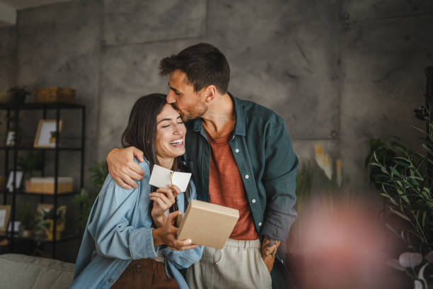 Girlfriend read greeting card thank you note from his boyfriend
