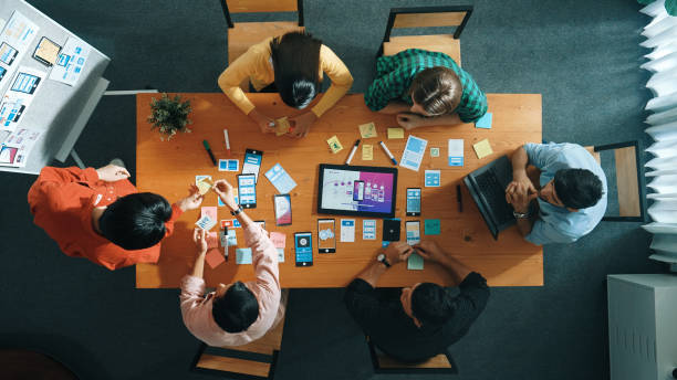 istock Top view of developer team working together to stick idea on board. Convocation. 2163519934