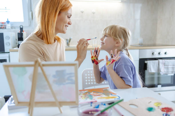 istock Mother and daughter bonding over creative painting activity at home 2163521127