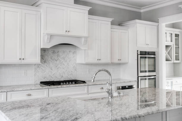 istock Modern Kitchen With White Cabinetry, Marble Countertops And Gas Range 2163522714