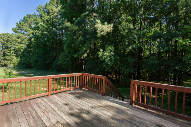 istock Wooden Deck In Backyard With Surrounding Tall Trees And Open Grassy Area 2163522720
