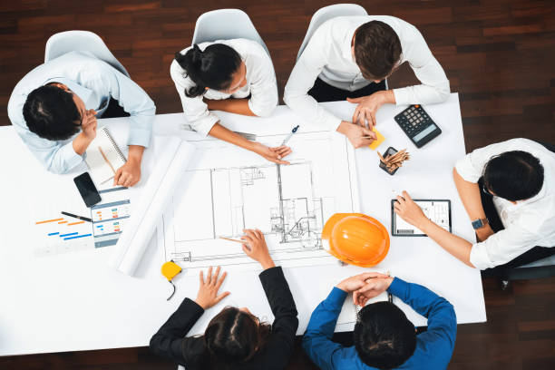 istock Diverse group of civil engineer and client working on architect. Prudent 2163523181