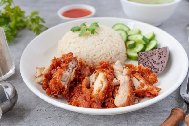 istock Fried Chicken and rice, rice, chicken, hainanese fried chicken rice, crispy fried chicken ,coriander, cucumber, asian food, thai cuisine, khao man gai tod 2163523959
