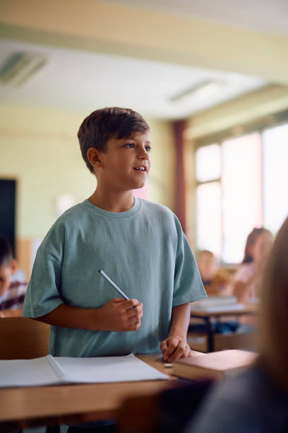 istock Happy schoolboy during a class in the classroom. 2163524019