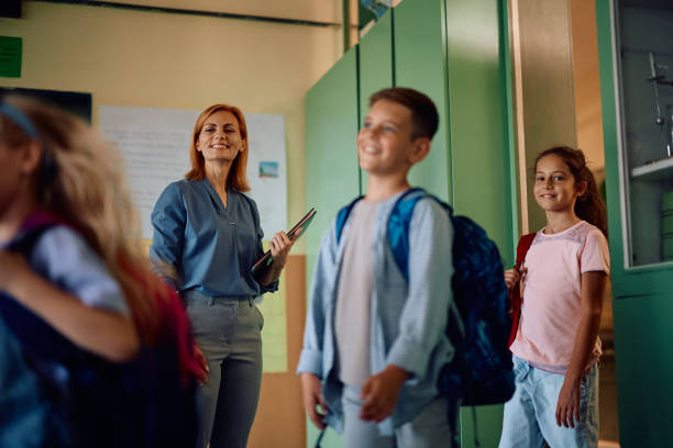 istock Happy school kids entering the classroom after summer break. 2163524065