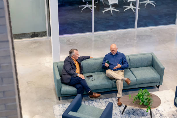 istock Two business men sitting on a couch 2163524296