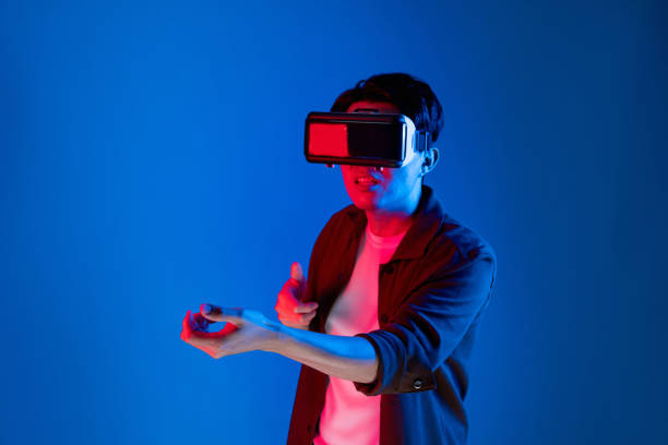 istock Gamer wearing VR turning meta playing hunter isolated neon light. Contrivance. 2163525239