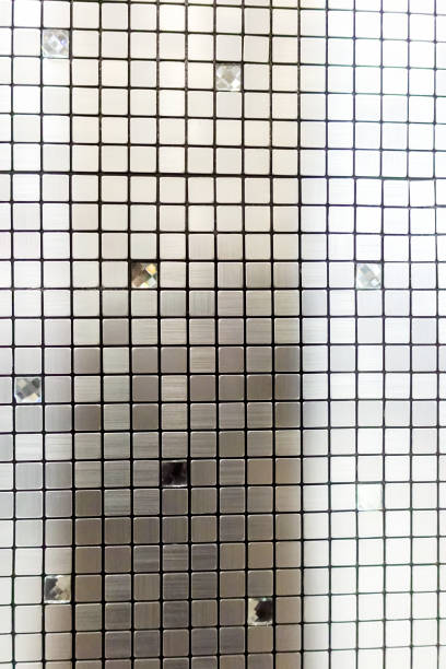 Metal background with reflective surface. The surface has a grid pattern of squares that adds a unique visual element to the design.
