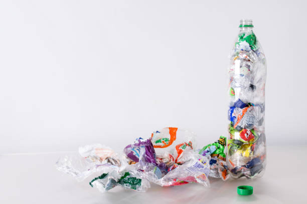 istock Ecobrick, transparent plastic bottle filled and compacted with plastic waste 2163533091