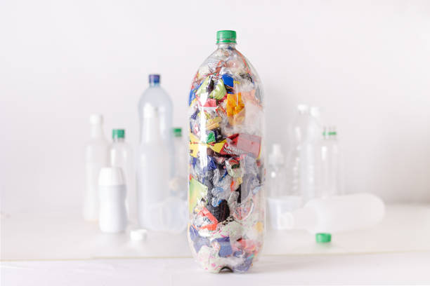istock Ecobrick, transparent plastic bottle filled and compacted with plastic waste 2163533151