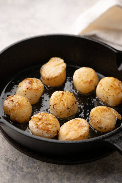 istock cooking sclallop on iron skillet pan 2163538422