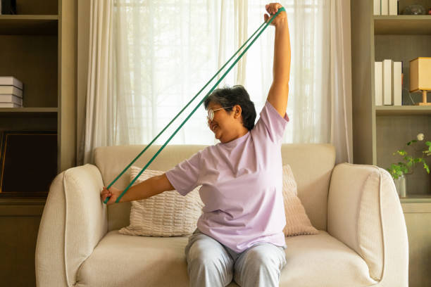 istock Asian elderly woman exercising at home. 2163539320