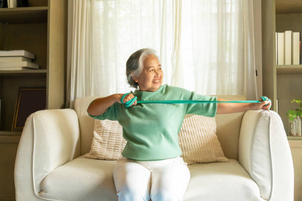 Asian elderly woman exercising at home.