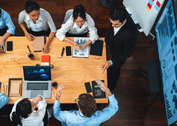 istock Wide top view diverse analyst team analyzing financial data. Habiliment 2163541328