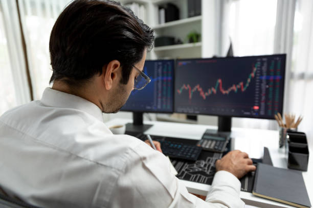 istock Trader analyzing in dynamic stock exchange investment screen on pc. Surmise. 2163543528