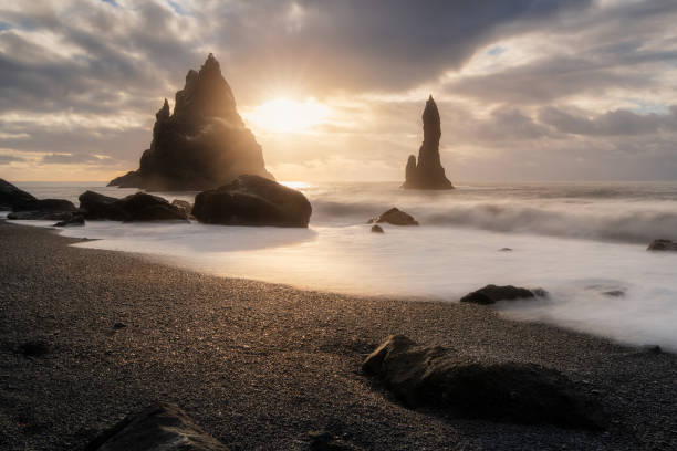 istock Black sand beach in Iceland, near Vik town, also called Reynisfjara, on Atlantic Ocean, sea stack formations, waves, colorful sunrise 2163544675