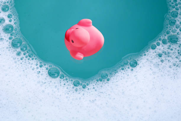 istock Pink rubber duck in water with soap foam 2163545579