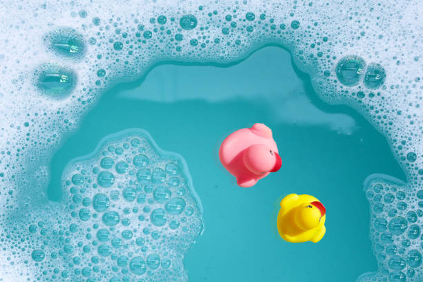 istock Rubber ducks in water with soap foam 2163545580