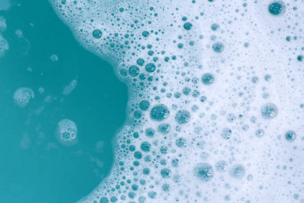 istock Detergent foam bubble on water. Blue background, Soap sud 2163545587