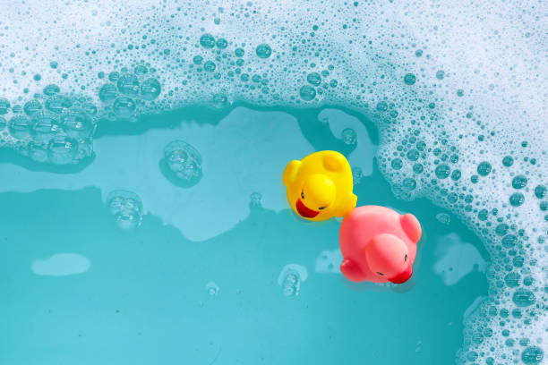 istock Rubber ducks in water with soap foam 2163545590