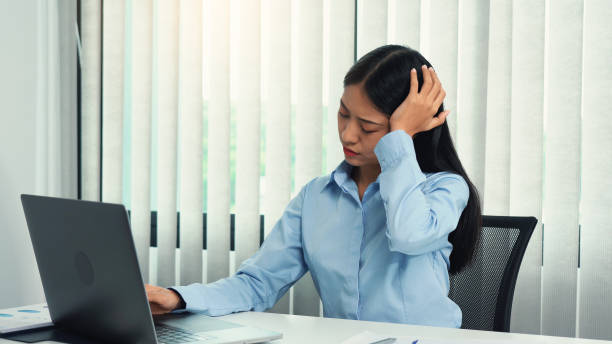 istock Asian woman sitting and working has a headache. 2163545730