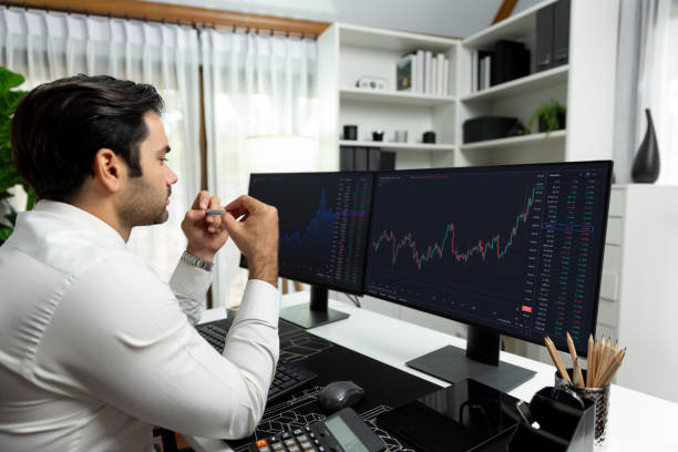 istock Trader analyzing in dynamic stock exchange investment screen on pc. Surmise. 2163545793