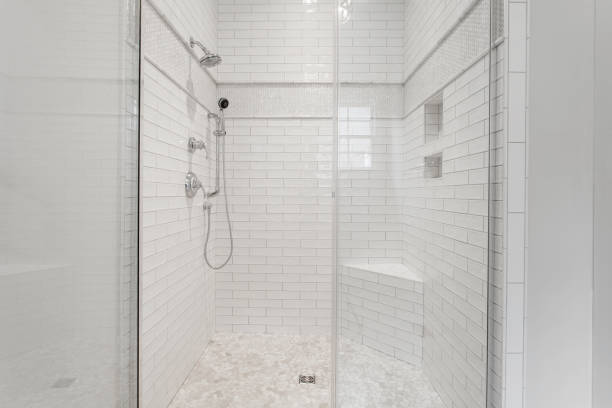 istock White Subway Tile Shower Enclosure With Glass Doors And Built-In Amenities. 2163548289