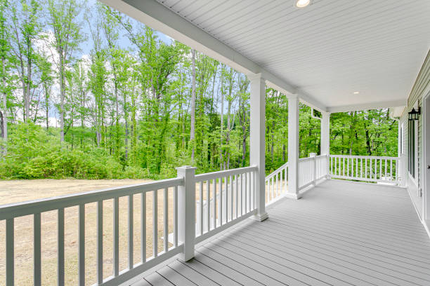 istock Spacious Front Porch With White Railings And A Scenic View Of Greenery. 2163548475