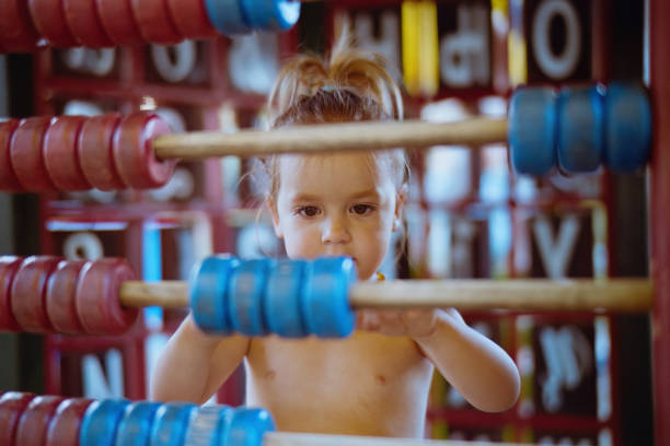 Cute girls learning to count on abacus. Shoot with Leica M6.
