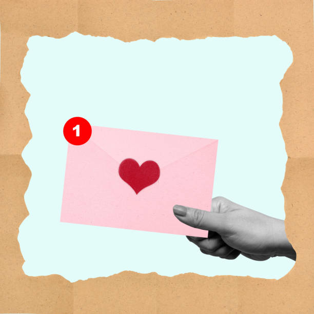 istock A hand holding a pink envelope with a heart on it 2163550324