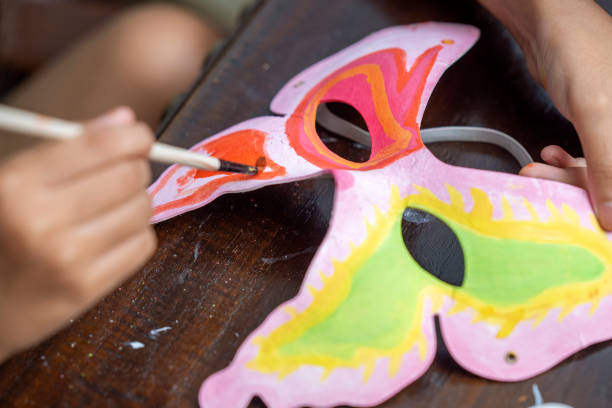 istock A person is painting a mask with a brush 2163552030