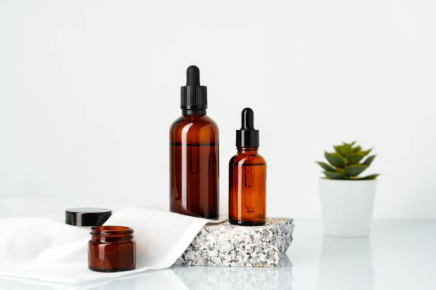 istock Amber Glass Bottles With Dropper Tops Displayed on a Stone Platform 2163552275