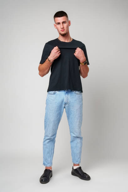 istock Young Man Wearing Black T-Shirt Against White Background 2163553184