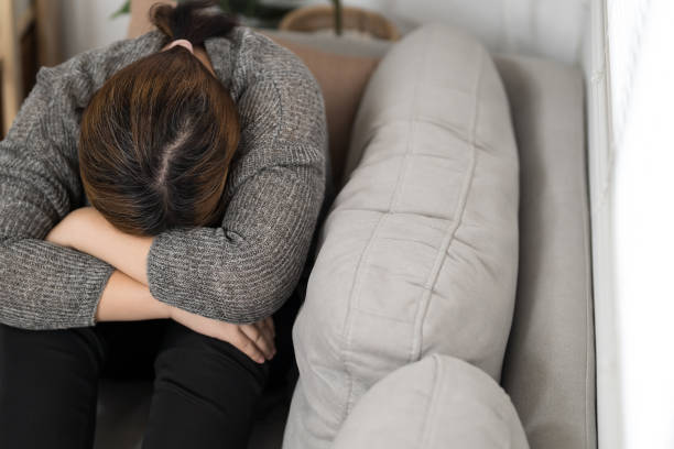 istock Sad Overweight plus size woman thinking about problems on sofa upset girl feeling lonely and sad from bad relationship or Depressed woman disorder mental health. 2163553512