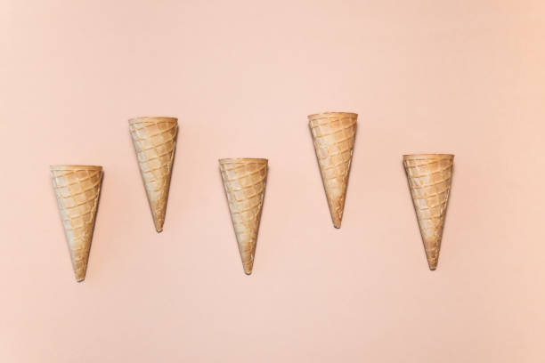 istock A row of five small ice-cream cones on a beige background 2163555314
