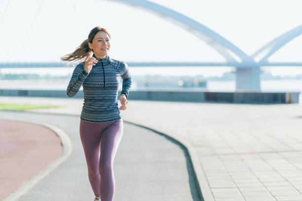 istock Happy sportswoman running 2163555826