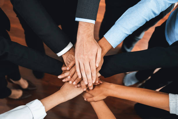 istock Multiracial business people make synergy hand stack together. Habiliment 2163555855