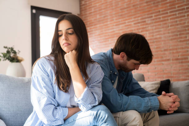 istock Close-up of unhappy young couple sitting apart have relationship problems, think about breakup or divorce. Family lovers, distraught men and women, avoid talking and suffer from betrayal in relationship problems. 2163556821